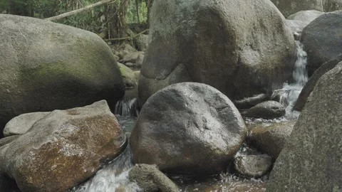 Small tropical river between large rocks. Loop. Stock Footage 332397400