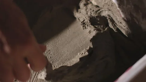 Small Trowel Mixing Grey Cement, 4K Artisan Detail, Slow Motion Macro Vídeos de archivo 328340845