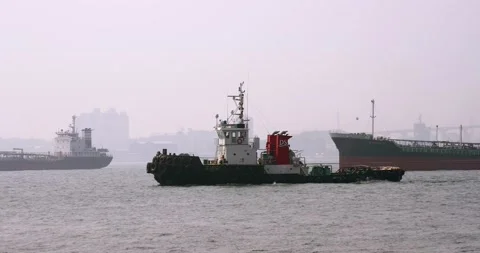 A small tug passes against the background of ships. Stock Footage 165622457