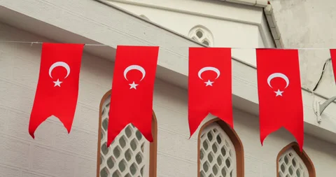 Small Turkish flags waving in string at city street of Istanbul Stock Footage 318675701