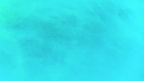 Small turquoise water ripples background texture. Bird's eye view. Stock Footage 281674355