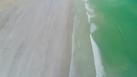 Small turquoise waves rolling in at a tropical beach Stock Footage 143999854