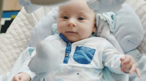 Small two months the baby is in the cradle. He does not sleep, smiling, close-up Stock Footage