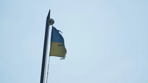 Small Ukrainian flag wawing on the wind in the clear sky on the cargo ship Stock Footage 105882453