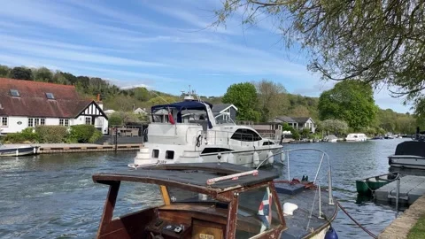 Small unkept boat and a large modern white yacht in the UK - river view 스톡 동영상 333230048