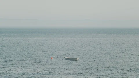Small unmanned boat bobbing in the sea in slow motion, 4k Stock Footage 111932953