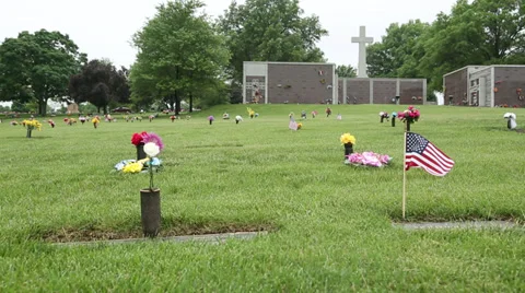 Small US Flag and flowers in Cemetery on Memorial Day Stock Footage 38836765