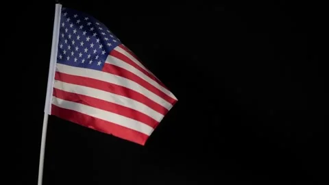 Small us flag blown on a black background Stock Footage 160558028