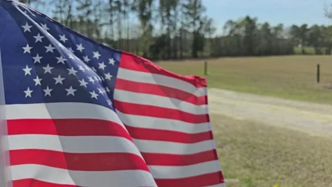 Small US Flag on Blue Sky Slow Speed Stock Footage 304636020