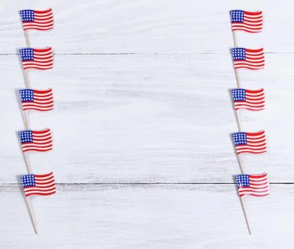 Small USA flags on each sides of white wooden boards Stock Photos