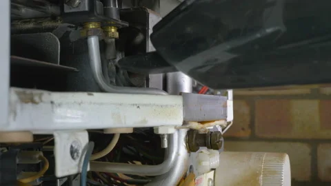 Small vacuum cleaner cleaning the inside of an old central heating boiler. Video stock 144098907