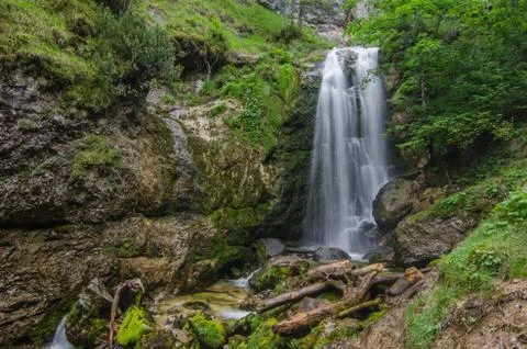 Small veil waterfall in the mountains while hiking Foto stock