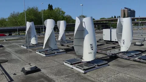 Small vertical axis wind turbines on the roof rotating 스톡 동영상 243262729
