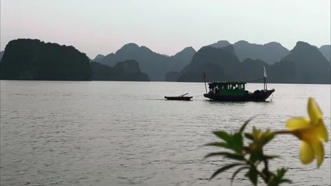 Small vessel pulling a rowboat in Halong bay, Vietnam Video stock 206343332