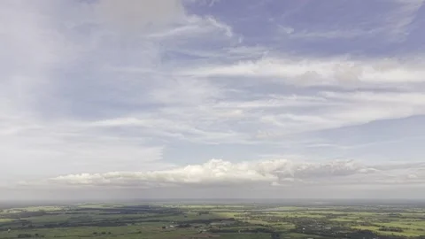 Small village clusters sit among wide green fields Stock Footage 344509195