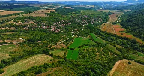 Small Village Hidden Between Trees In Rural Bulgarian Countryside Aerial Zoom In Video stock 300442807