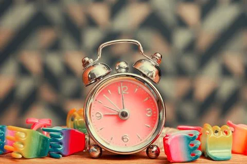 Small vintage alarm clock with timer and girls accessories Stock Photos