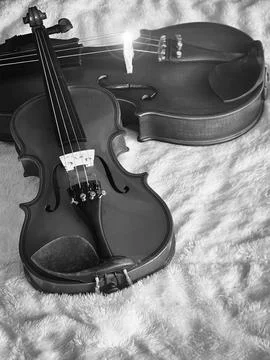 Small violin put in front of blurred bigger one,on soft cotton cloth,show d.. Stock Photos