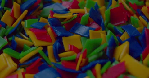 Small vivid plastic pieces prepared for recycling purposes. Stock Footage 327876222