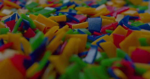 Small vivid plastic pieces prepared for recycling purposes. Stock Footage 327876337