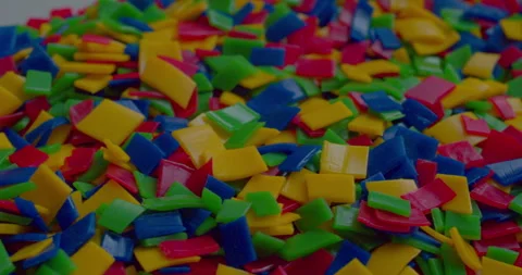 Small vivid plastic pieces prepared for recycling purposes. Stock Footage 327876662