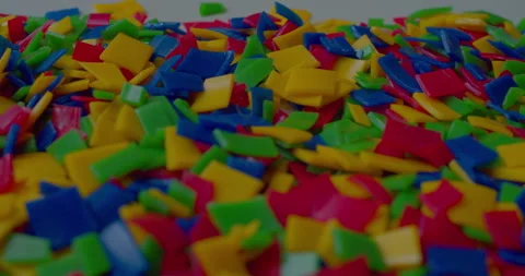 Small vivid plastic pieces prepared for recycling purposes Stock Footage 327877484