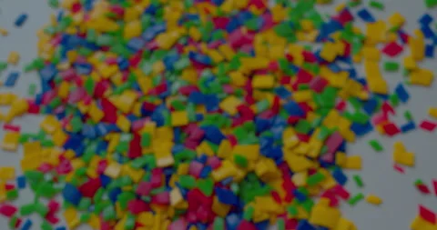 Small vivid plastic pieces prepared for recycling purposes. Stock Footage 327877936