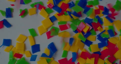 Small vivid plastic pieces prepared for recycling purposes Stock Footage 327878373