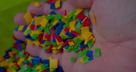 Small vivid plastic pieces prepared for recycling purposes. Stock Footage 327880631
