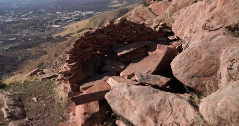 Small wall made out of local rocks built into a fort and seating area Stock Footage 120279316