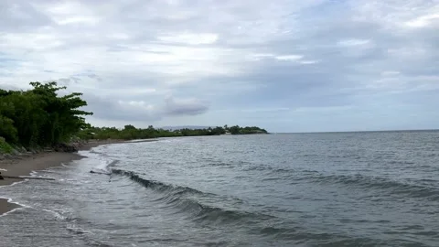 Small warm waves on the sandy shore of the sea gently stroke the shore Stock-Footage 238578506