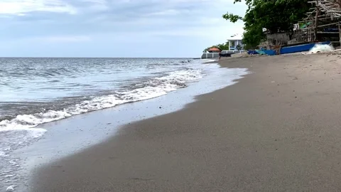 Small warm waves on the sandy shore of the sea gently stroke the shore Stock Footage 238578658