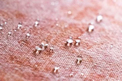 Small Water Droplets Formed Into Tiny Balls On Textured Carpet Background. Stock Photos