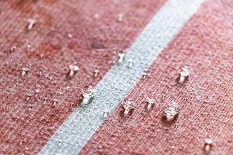 Small Water Droplets Formed Into Tiny Balls On Textured Carpet Background. Stock Photos