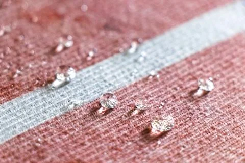Small Water Droplets Formed Into Tiny Balls On Textured Carpet Background. Stock Photos