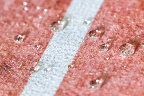 Small Water Droplets Formed Into Tiny Balls On Textured Carpet Background. Stock Photos