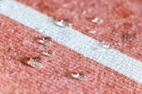 Small Water Droplets Formed Into Tiny Balls On Textured Carpet Background. Stock Photos