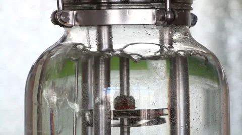 Small water filled bioreactor in action vertical panning down Stock Footage 62302525