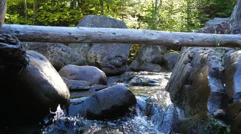 Small water rapids flowing through many rocks Stock Footage 62420783