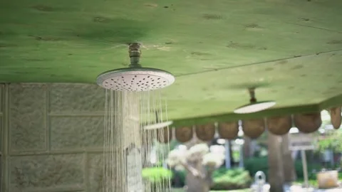 Small water streams fall from shower under green ceiling Stock Footage 158075150