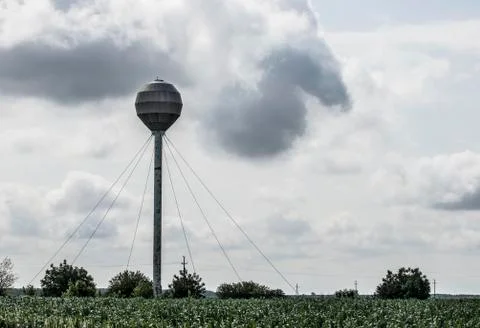 Small water tower with dark clouds Stock Photos