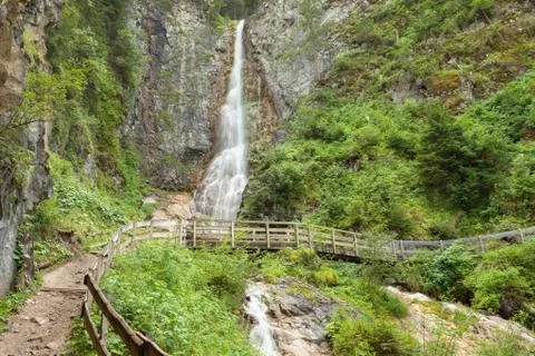 Small waterfall among the forest in Val Gardena Stock Photos
