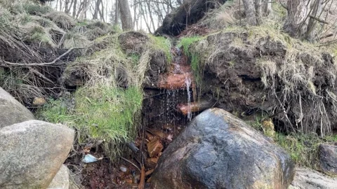 A small waterfall among rocks and grass. Stock Footage 306322808