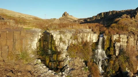 Small waterfall at Ancient Lakes at sunset with high bluffs and cliffs Stock Footage 144135276