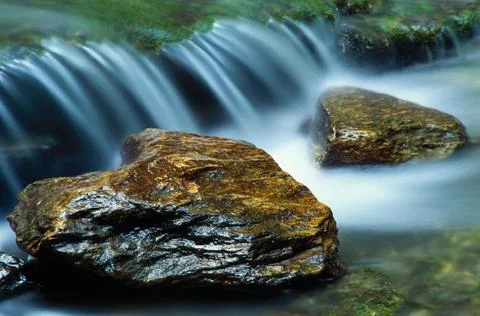 Small waterfall and a pair of river rocks Stock-Fotos