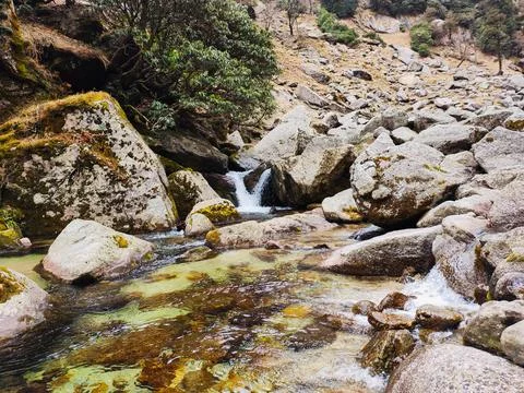 Small waterfall and rock pool in mountain stream, Kareri Lake, Himachal Pradesh. Stock Photos