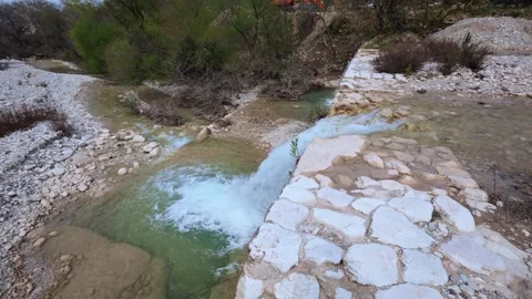 Small Waterfall and Stone Dam Stopping a River Flow Stock Footage 305236178
