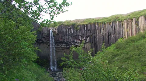 Small waterfall on basaltic volcanic rock hexagonal columns Stock Footage 38021074