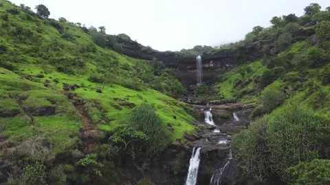 Small Waterfall between green fields on a misty day in monsoon Video stock 157286049