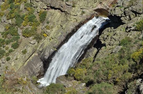 Small waterfall between the rocks of a mountainside, small river Stock Photos